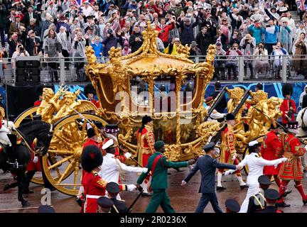 King Charles III and Queen Camilla are carried in the Gold State Coach, pulled by eight Windsor Greys, in The Coronation Procession as they return along The Mall to Buckingham Palace, London, following their coronation ceremony. Picture date: Saturday May 6, 2023. Stock Photo