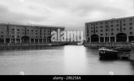 Floating Earth Artwork  and visitors at Liverpool's Albert Dock Stock Photo