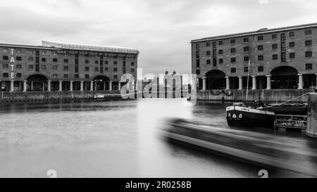 Floating Earth Artwork  and visitors at Liverpool's Albert Dock Stock Photo