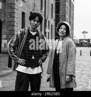 Floating Earth Artwork  and visitors at Liverpool's Albert Dock Stock Photo