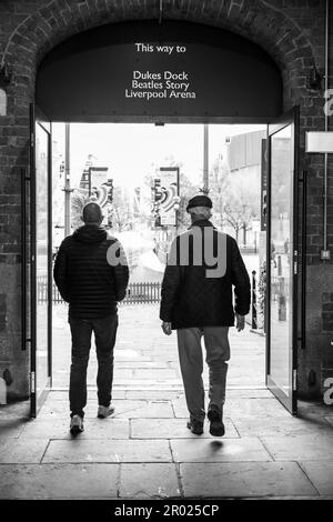 Floating Earth Artwork  and visitors at Liverpool's Albert Dock Stock Photo