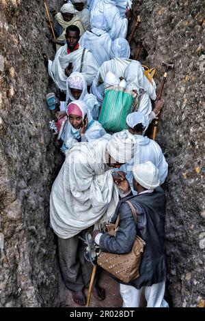 Lalibela, Ethiopia - January 5, 2018: Pilgrims in the corridor leading to the Biete Giyorgis (Church of Saint George) in Lalibela, Ethiopia. Stock Photo