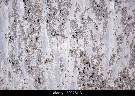 Background of brown polished stone texture with abstract pattern, for design, uneven surface. Copy space. Selective focus. Stock Photo