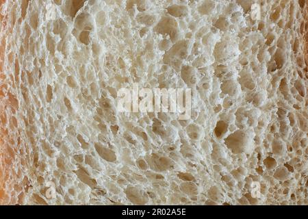 surface of white bread in full frame, popular food item in many cultures and used for making sandwiches, toast, and other dishes, lighter color Stock Photo
