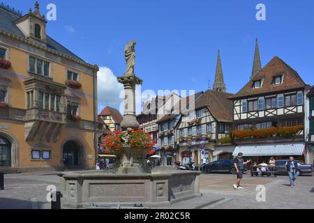 France, Alsace, Obernai, city centre, old town, market place, Obernai/Alsace with fountain and town hall (left) . In the background the towers of the Stock Photo