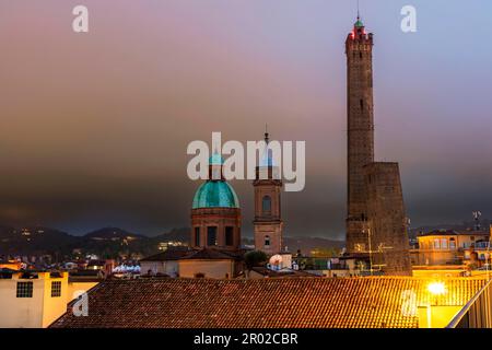 The leaning towers Garisenda and Asinelli with the church Santi Bartolomeo and Gaetano in the historic centre, Bologna, Emilia, Romagna, Italy Stock Photo