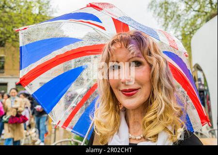 London, UK. 06th May, 2023. Union jack umbrellas - A street party supported by Cadogan Estates is held in rainy weather on the Kings Road. The Coronation of King Charles III on May 6th. Credit: Guy Bell/Alamy Live News Stock Photo