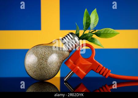 Plug, plant growing inside the light bulb and Sweden Flag. Green eco renewable energy concept. Stock Photo