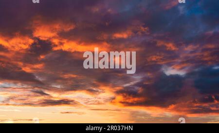 Colorful dark vibrant dramatic sunset with cloudy sky atmosphere Stock Photo
