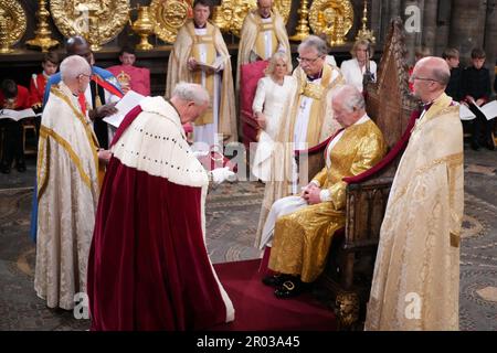 Lord Carrington, Lord Great Chamberlain, presenting the Spurs to King Charles III during his coronation ceremony at Westminster Abbey, London. Picture date: Saturday May 6, 2023. Stock Photo