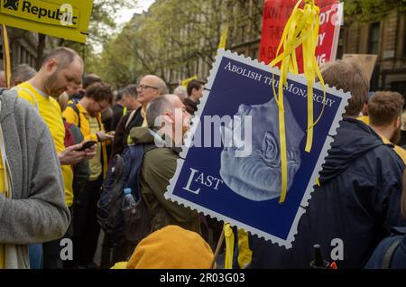 London, UK. 06th May, 2023. Anti-monarchy protestors with a placard showing a fake stamp with 'Abolish the monarchy' printed on it demonstrate in Trafalgar Square in central London on 6 May, 2023, as the coronation of King Charles III took place a short distance away.    Earlier, the head of the anti-monarchist campaign group Republic and a number of activists were  arrested by police in Trafalgar Square. It was the first coronation of a new monarch in London, UK, for 70 years and despite steady rain, many thousands of people descended on the capital city to enjoy the celebrations. Credit: And Stock Photo