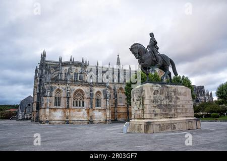 Square with monument in front of Batalha Cathedral in Portugal Stock Photo