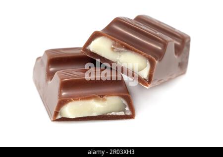 Pieces of chocolate with soft milk filling on a white background. Chocolate bar. Pastry Stock Photo