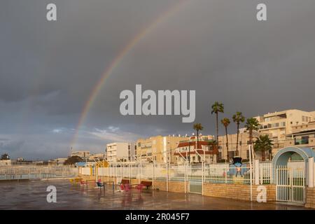Twin rainbow over the sea beach in the city Nahariya in israel. Cloudy day. Stock Photo