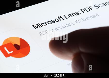 Microsoft Lens app seen in App Store on the screen of ipad and blurred finger pointing at it. Selective focus. Stafford, United Kingdom, May 6, 2023 Stock Photo