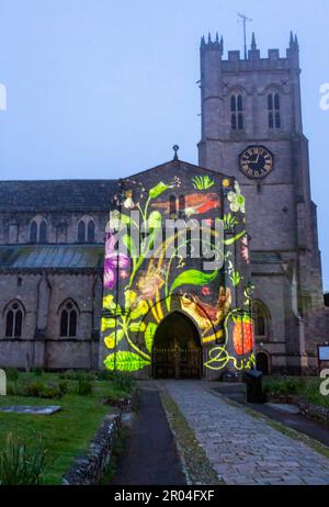 Christchurch, Dorset, UK. 6th May, 2023. Christchurch's Coronation Light Display with special images and animation celebrating the Coronation of King Charles III projected on to the front of Christchurch Priory, created by Light Art Creatives in collaboration with Event Temps UK. Crowds flock to the Priory on a misty murky evening to see reminders of this historic event - the first time Christchurch Priory has hosted a projected light display. Credit: Carolyn Jenkins/Alamy Live News Stock Photo