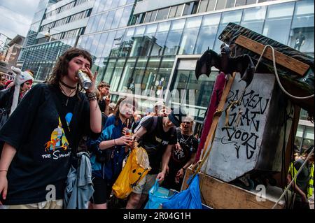 Protesters are seen dancing and drinking behind one of the trucks playing hard music during the demonstration. In the increasingly crowded city of Utrecht, there must always be a room for creative 'fray edges' in order to promote independent art and culture. With that call in mind, a demonstrative rave was organized in the city center. The parade through the city, counted with the presence of around fifteen music cars accompanied by people dancing. The organization believes that the municipality lacks a permanent vision of cultural sanctuaries. Stock Photo