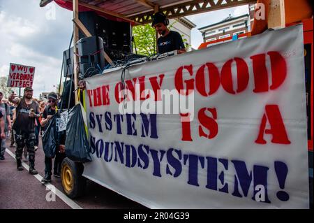 Protesters are seen dancing behind one of the trucks with a whole sound system installed during the demonstration. In the increasingly crowded city of Utrecht, there must always be a room for creative 'fray edges' in order to promote independent art and culture. With that call in mind, a demonstrative rave was organized in the city center. The parade through the city, counted with the presence of around fifteen music cars accompanied by people dancing. The organization believes that the municipality lacks a permanent vision of cultural sanctuaries. Stock Photo