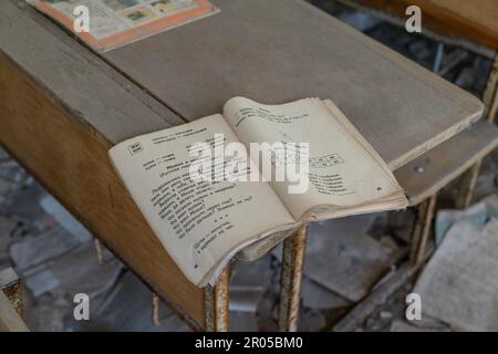 Ukraine. 06th May, 2023. View of interior of classroom with desks and books on student's desks in school in abandoned city of Pripyat in Ukraine from where all dwellers were evacuated after disaster on Chernobyl nuclear plant. (Photo by Lev Radin/Pacific Press) Credit: Pacific Press Media Production Corp./Alamy Live News Stock Photo