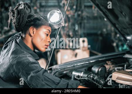 Experienced auto mechanics inspect car battery terminals and voltage to