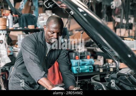 Experienced auto mechanics inspect car battery terminals and voltage to