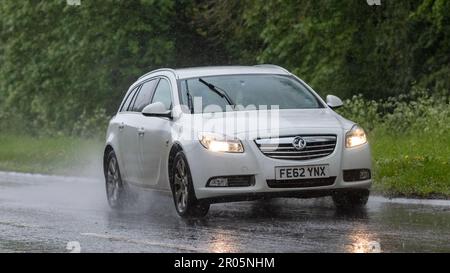 Stony Stratford,Bucks,UK - May 6th 2023. 2012 white VAUXHALL INSIGNIA  driving in the rain on a wet road Stock Photo