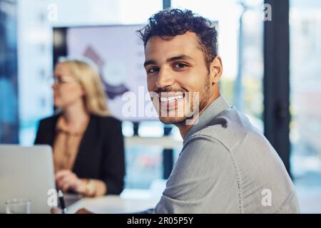 Weve met every objective on our meeting agenda. Portrait of a confident young businessman having a meeting with colleagues in the boardroom of a Stock Photo