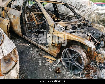 A cropped front view of a burned and abandoned rusty cars Stock Photo ...