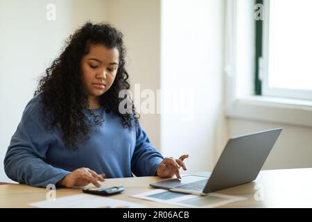 Young hispanic woman accountant working from home office Stock Photo