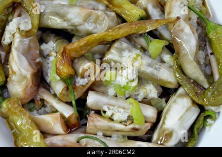 Pickled roast fried aubergine and green peppers stuffed with garlic, chili red pepper,vinegar, lemon, coriander, parsley, chopped tomatoes and spices, Stock Photo