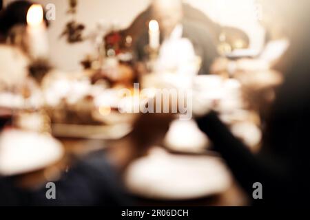 Lets never forget what this day is about. unrecognizable people holding hands in prayer before having a Christmas lunch together. Stock Photo