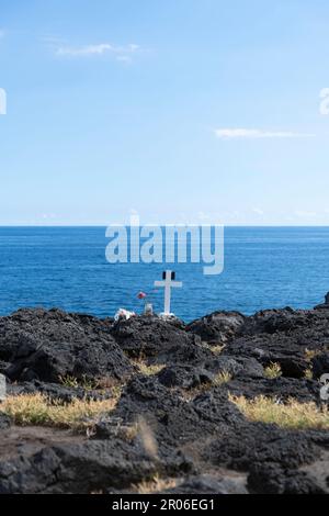 Cross and Flowers, Honouring Loved Ones on the Coast of La Réunion, France, Symbolic Significance, copy space Stock Photo
