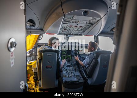 04 May 2023, Brandenburg, Schönefeld: Flight captain Lieutenant Colonel Michael Weyerer (l), photographed on board the Airbus A350-900 'Konrad-Adenauer' of the BMVg's Special Air Mission Wing on Chancellor Scholz's flight from Berlin to Addis Ababa. The Bundeswehr Air Force's flight readiness unit handles the German government's flights at home and abroad. Photo: Michael Kappeler/dpa Stock Photo
