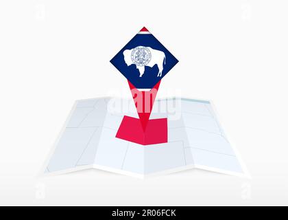 Wyoming is depicted on a folded paper map and pinned location marker with flag of Wyoming. Folded vector map. Stock Vector