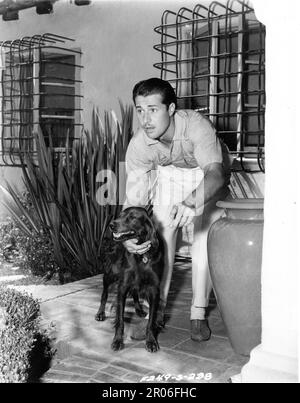 DON AMECHE 1939 candid portrait at Home with his Dog publicity for Twentieth Century Fox Stock Photo