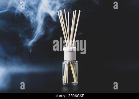 Home fragrance diffuser on dark background. Wellness and spa concept. Stock Photo