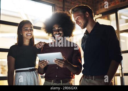 Three heads are better than one. a group of young designers having a brainstorming session in the boardroom. Stock Photo
