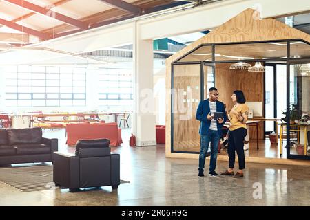 Creative ideas are always flowing in abundance in this office. two designers working on a digital tablet together in an office. Stock Photo