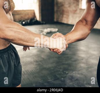 Double the strength. two unrecognizable men greeting each other with a handshake on a good workout exercise in the gym. Stock Photo