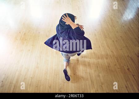 At the top of his dance game. High angle shot of a young man breakdancing in a studio. Stock Photo