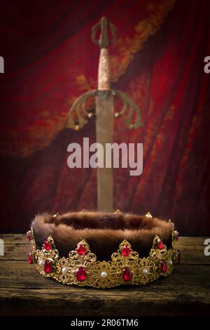 Golden king's crown and brass conquistador sword. This is a Spanish 19th  century Toledo sword as used by medieval knights Stock Photo - Alamy