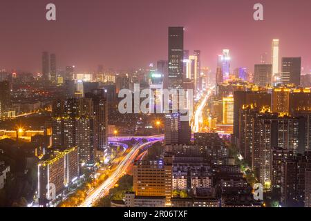 modern complex and traffic along on busy road from daytime to evening photo at high-rise building near junction of Liuyang and Xiangjiang rivers, Chan Stock Photo