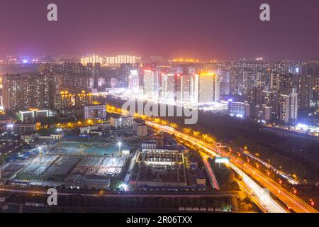 modern complex and traffic along on busy road from daytime to evening photo at high-rise building near junction of Liuyang and Xiangjiang rivers, Chan Stock Photo