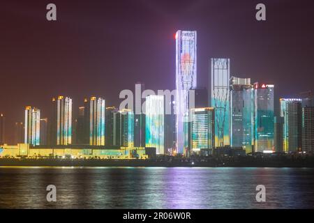 night view of high-rise buildings along Liuyang River near the junction with Xiangjiang river, Changsha, Hunan, China Stock Photo