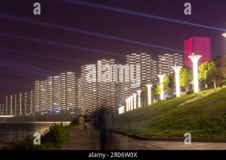 night view of high-rise buildings along Liuyang River near the junction with Xiangjiang river, Changsha, Hunan, China Stock Photo