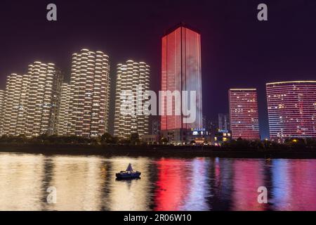 night view of high-rise buildings along Liuyang River near the junction with Xiangjiang river, Changsha, Hunan, China Stock Photo