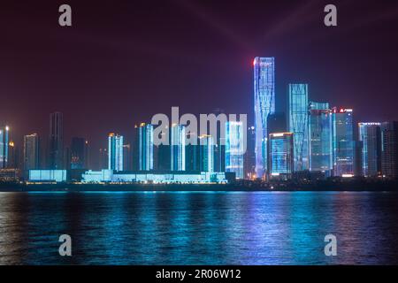 night view of high-rise buildings along Liuyang River near the junction with Xiangjiang river, Changsha, Hunan, China Stock Photo