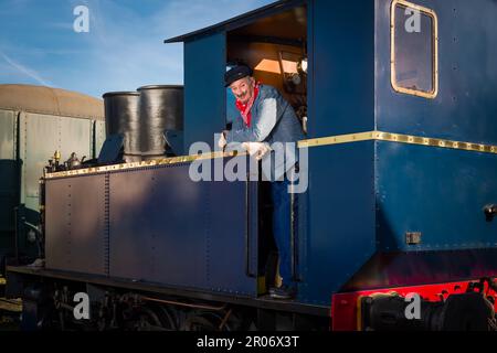 Reenactment scenes of a vintage worker or machinist in an authentic 1922 locomotive with restored engine Stock Photo