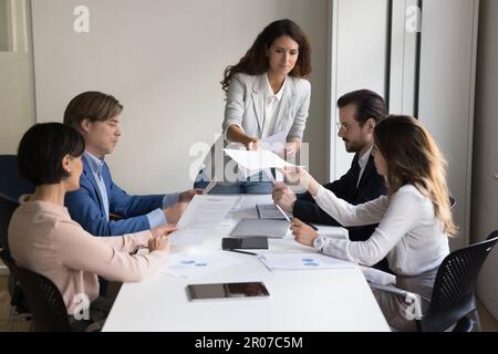 Businesspeople reviewing contract terms and conditions during meeting in office Stock Photo