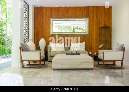 Soft and comfortable sofa with cushions in the lounge area with nice relaxing atmosphere. Cozy gorgeous comfortable resting area. Stock Photo